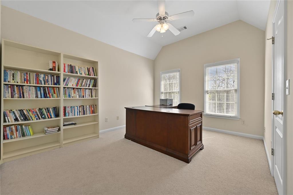 3945 Summit Gate Drive Suwanee, GA 30024 - Photo 37 of 45 a living room with furniture and a book shelf
