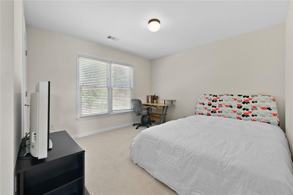3945 Summit Gate Drive Suwanee, GA 30024 - Photo 39 of 45 a bedroom with a bed and a window