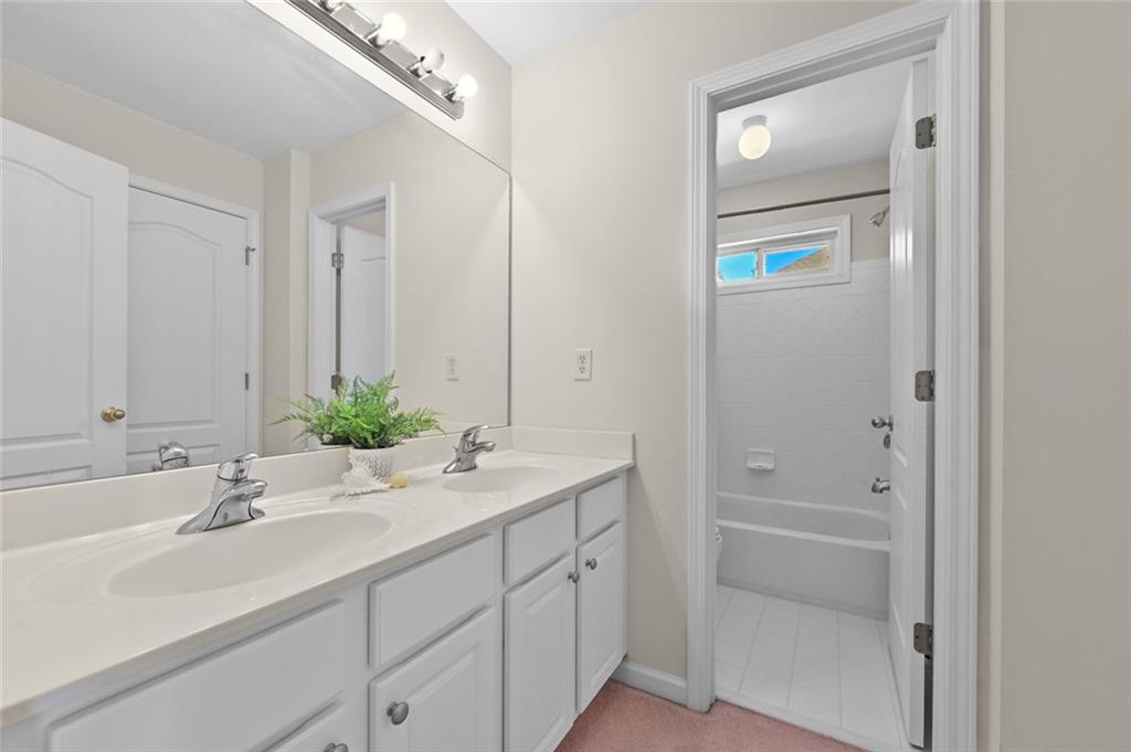 3945 Summit Gate Drive Suwanee, GA 30024 - Photo 41 of 45 a bathroom with a sink and a mirror