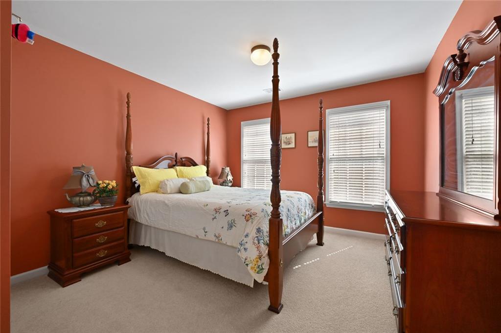 3945 Summit Gate Drive Suwanee, GA 30024 - Photo 42 of 45 a bedroom with bed table and window