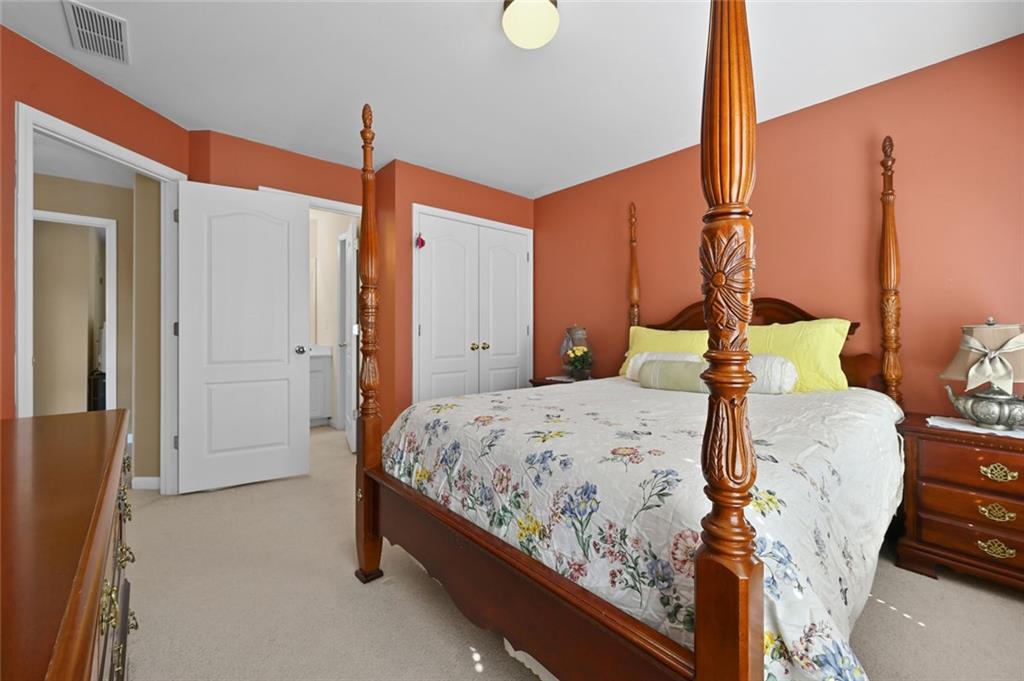 3945 Summit Gate Drive Suwanee, GA 30024 - Photo 43 of 45 a bedroom with a bed and wooden floor