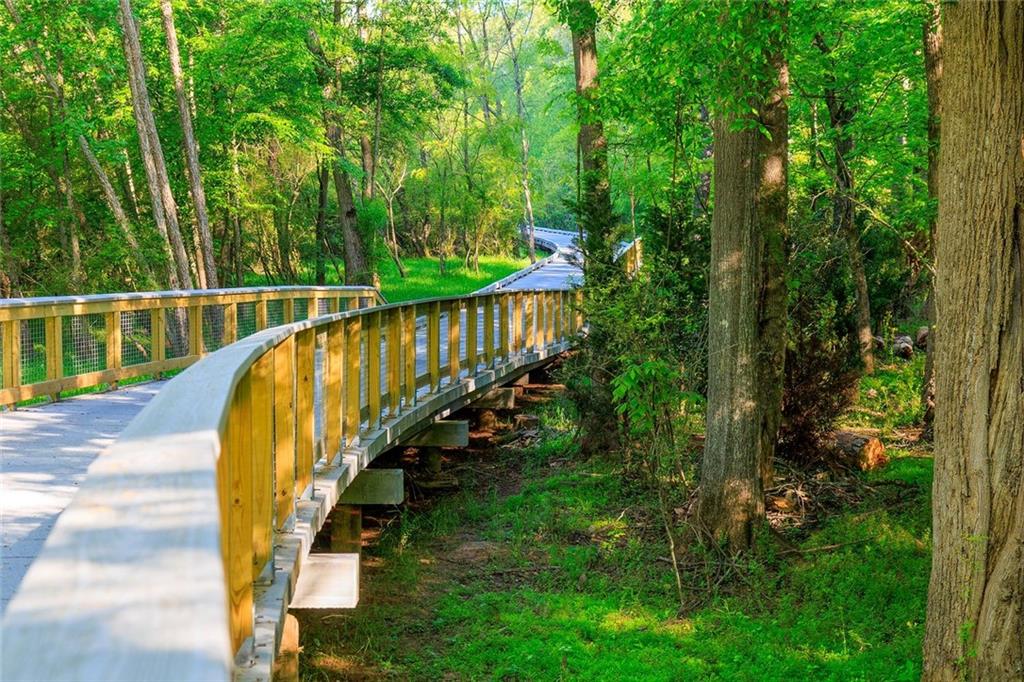 3945 Summit Gate Drive Suwanee, GA 30024 - Photo 10 of 45 a view of a swimming pool with a garden