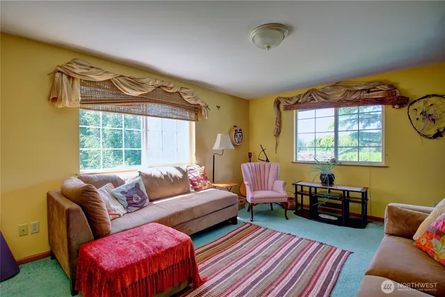 a bedroom with a bed wooden floor and window