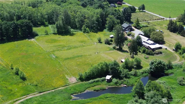 an aerial view of a house with a yard basket ball court and outdoor seating