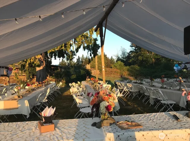a backyard of a house with table and chairs