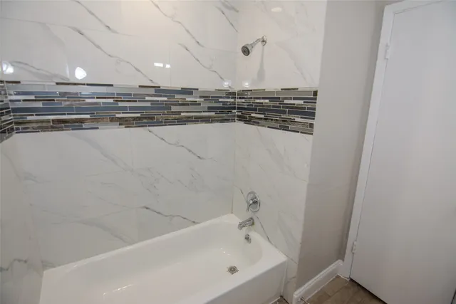 a bathroom with a bathtub and a sink