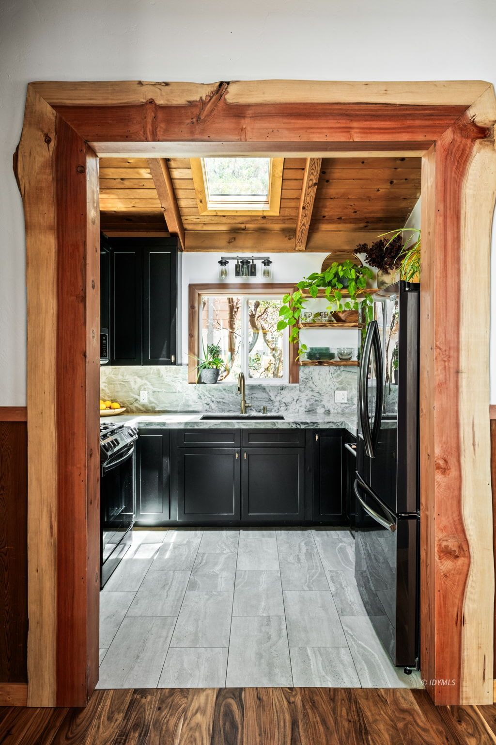 24750 Marion Ridge Drive Idyllwild, CA 92549 - Photo 18 of 45 a kitchen with a wooden floor and a refrigerator