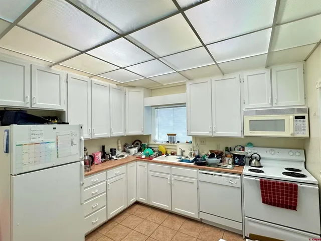 a kitchen with cabinets appliances a sink and a counter space