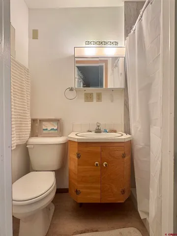 a bathroom with a sink a toilet and mirror