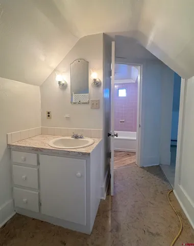 a bathroom with a sink a vanity and a mirror