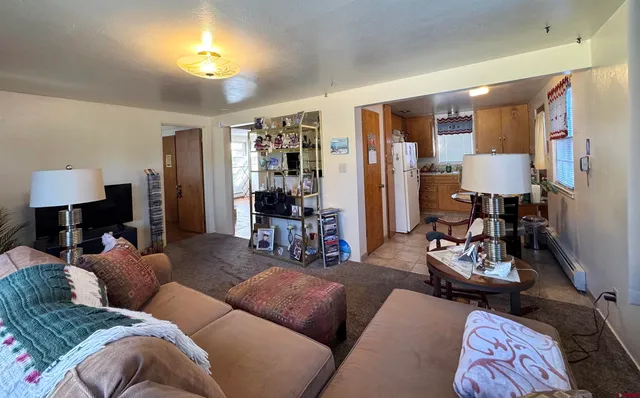 a living room with furniture and a lamp