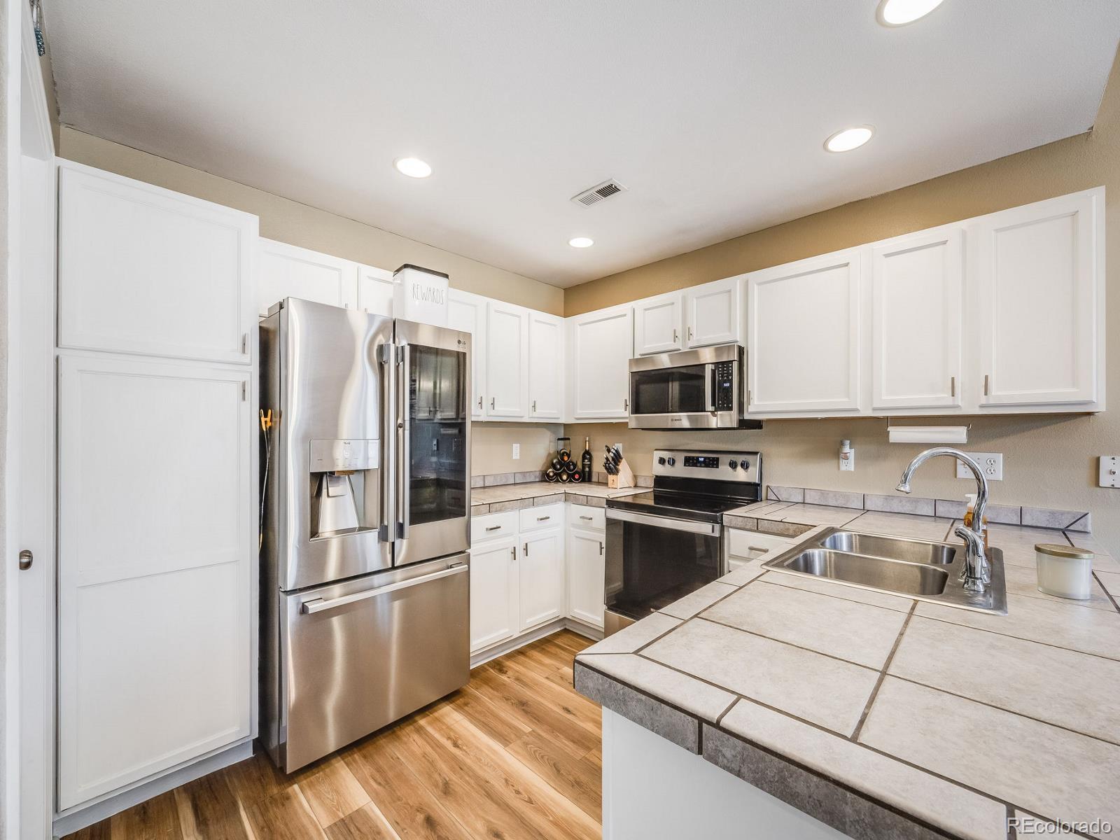 6360 Viewpoint Avenue Firestone, CO 80504 - Photo 11 of 27 a kitchen with stainless steel appliances granite countertop a refrigerator stove microwave and sink