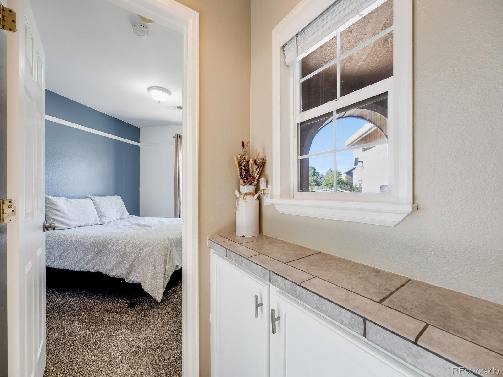 6360 Viewpoint Avenue Firestone, CO 80504 - Photo 15 of 27 a bedroom with a bed and a painting on the wall