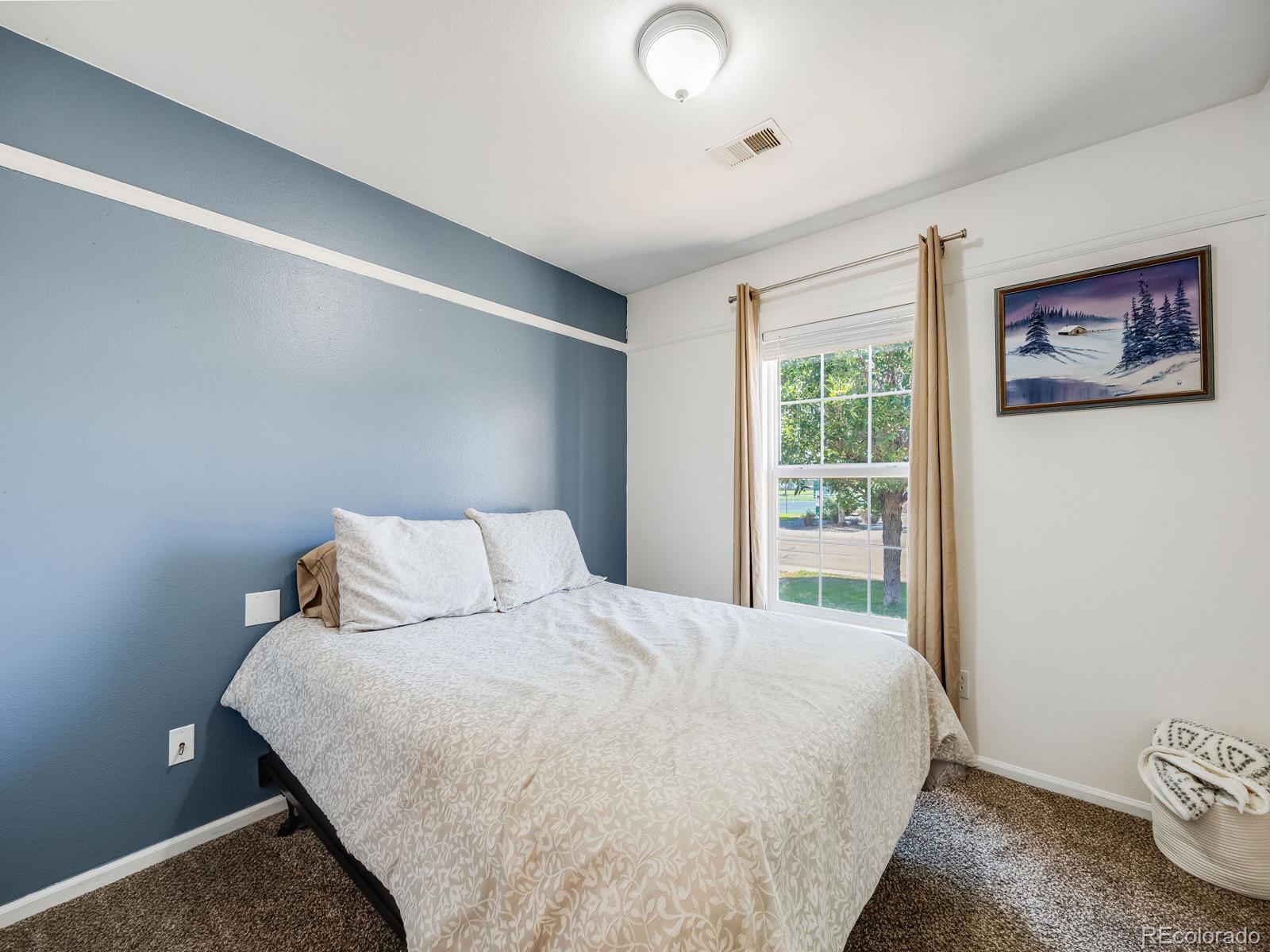 6360 Viewpoint Avenue Firestone, CO 80504 - Photo 17 of 27 a large bed sitting in a bedroom next to a window