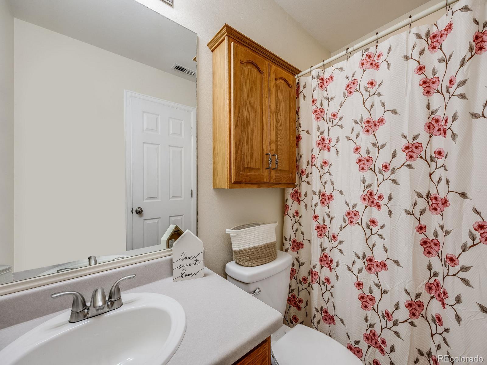 6360 Viewpoint Avenue Firestone, CO 80504 - Photo 18 of 27 a bathroom with a sink and mirror with toilet