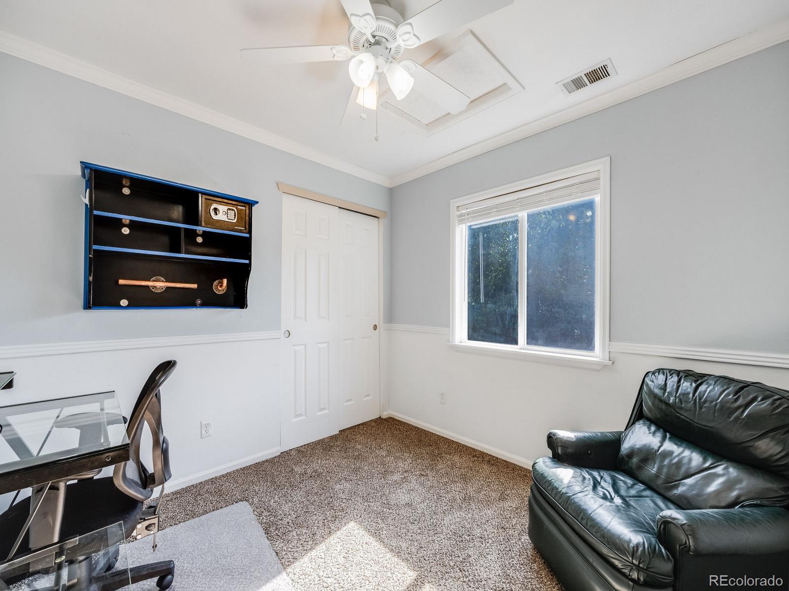 6360 Viewpoint Avenue Firestone, CO 80504 - Photo 19 of 27 a living room with furniture and a flat screen tv