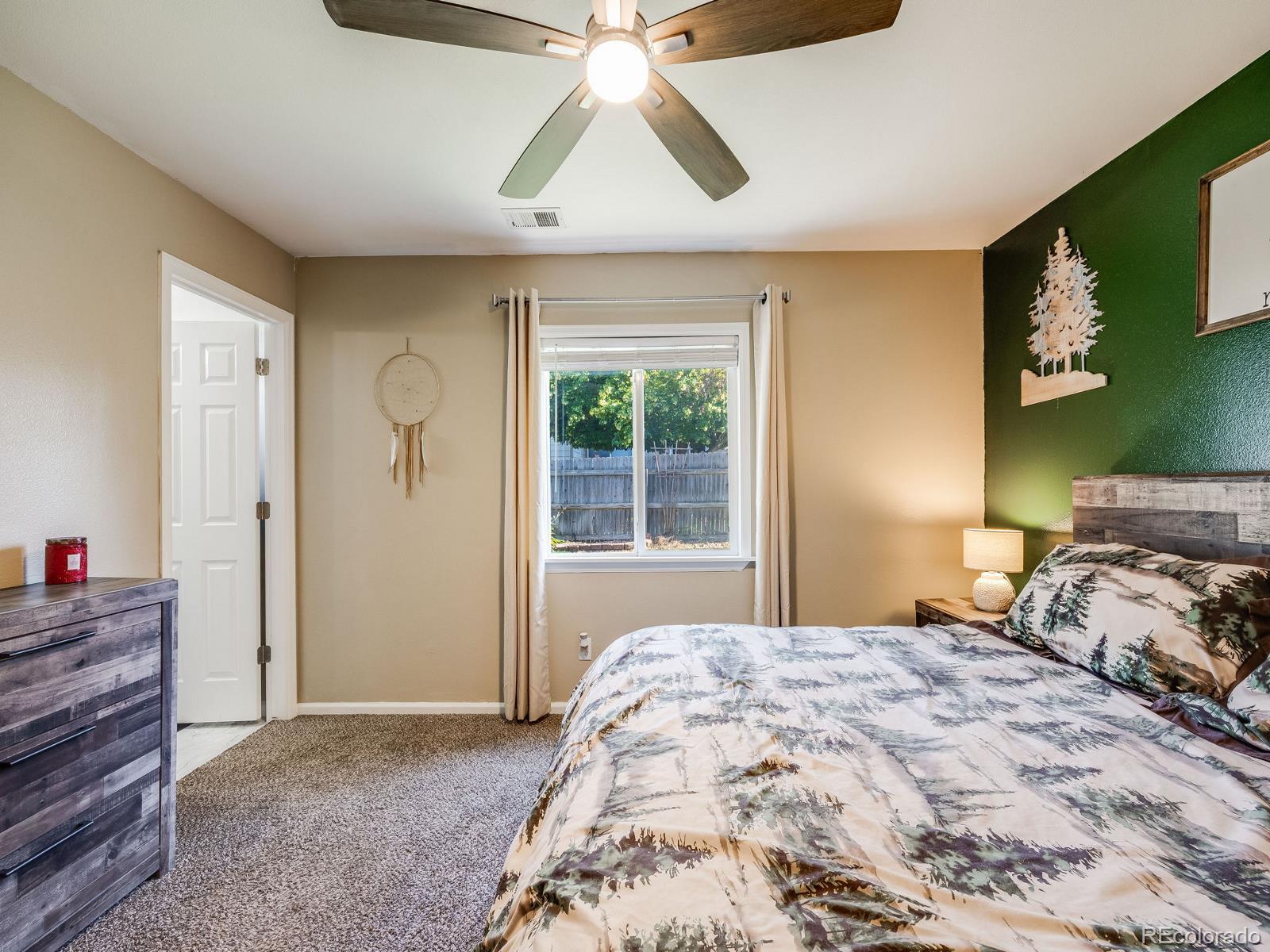 6360 Viewpoint Avenue Firestone, CO 80504 - Photo 22 of 27 a bedroom with a bed and a chandelier