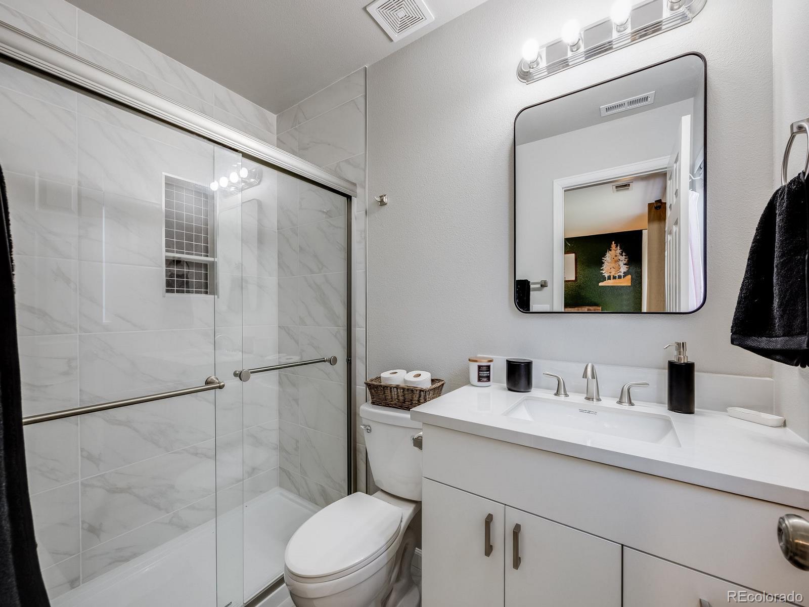 6360 Viewpoint Avenue Firestone, CO 80504 - Photo 23 of 27 a bathroom with a toilet sink and shower