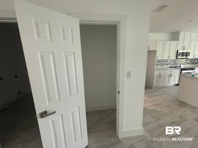 23348 Dundee Circle Foley, AL 36535 - Photo 8 of 21 Hall with baseboards and light marble finish floors