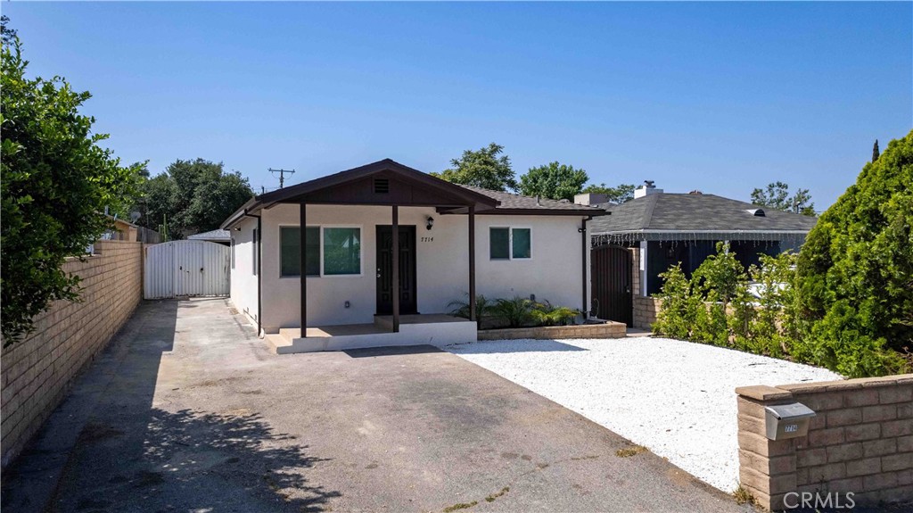 a front view of a house with a garden