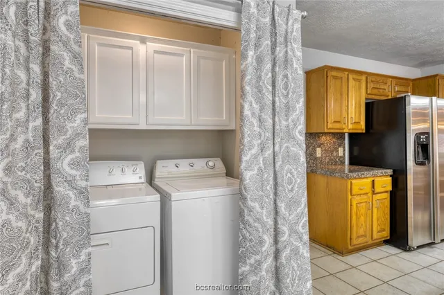 an empty room with wooden floor chandelier fan and windows