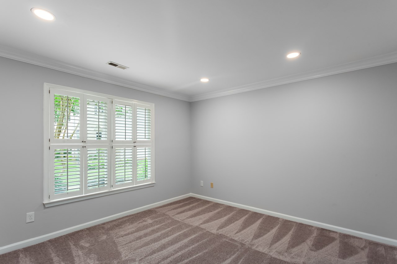 6903 Saxby Court Raleigh, NC 27613 - Photo 6 of 11 The 1st floor bedroom features fresh paint, new carpet and plantation shutters. 1st Floor Bedroom
