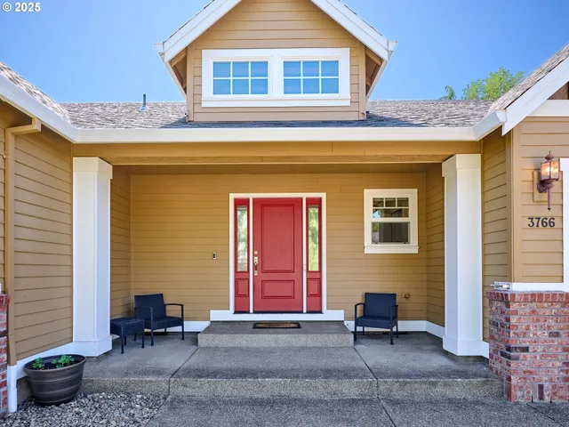 a front view of a house with outdoor seating