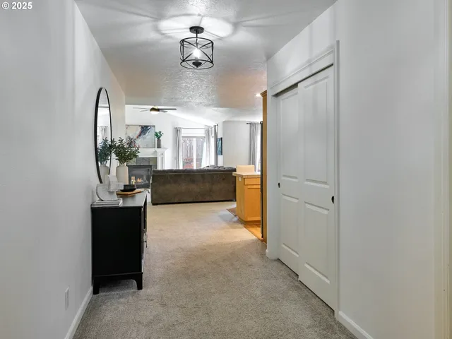 a kitchen with stainless steel appliances a dining table chairs refrigerator and sink