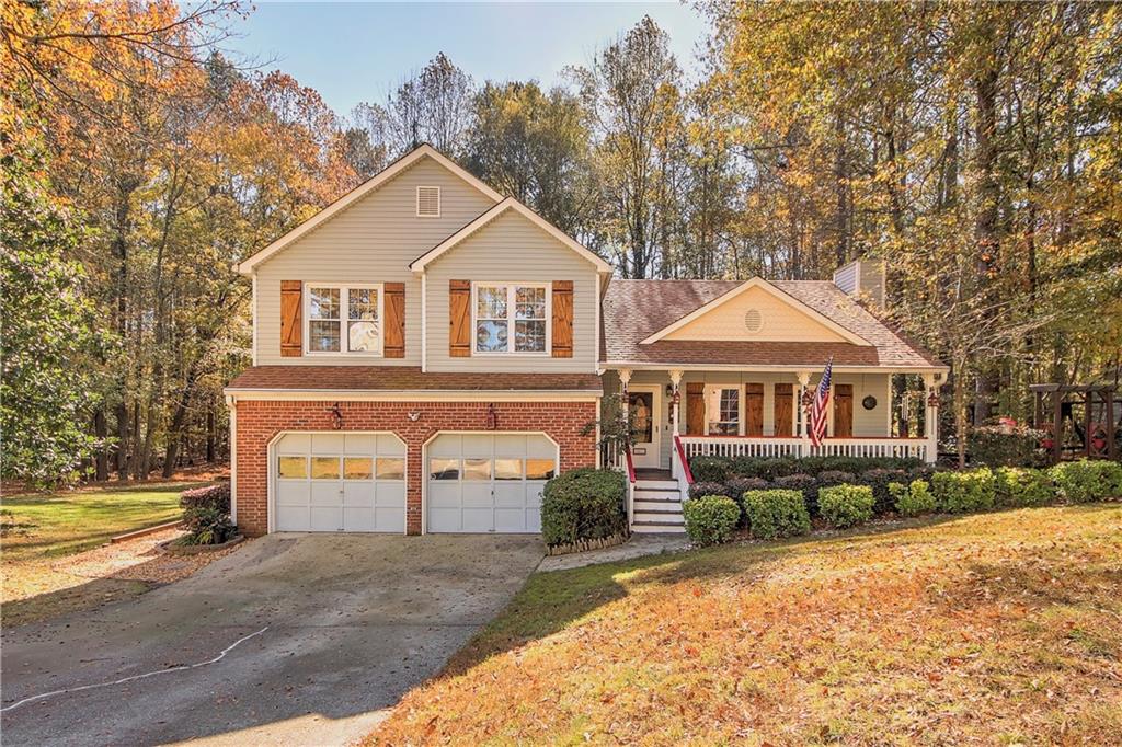 5481 Quarters Way Powder Springs, GA 30127 - Photo 1 of 1 a front view of a house with a yard and garage