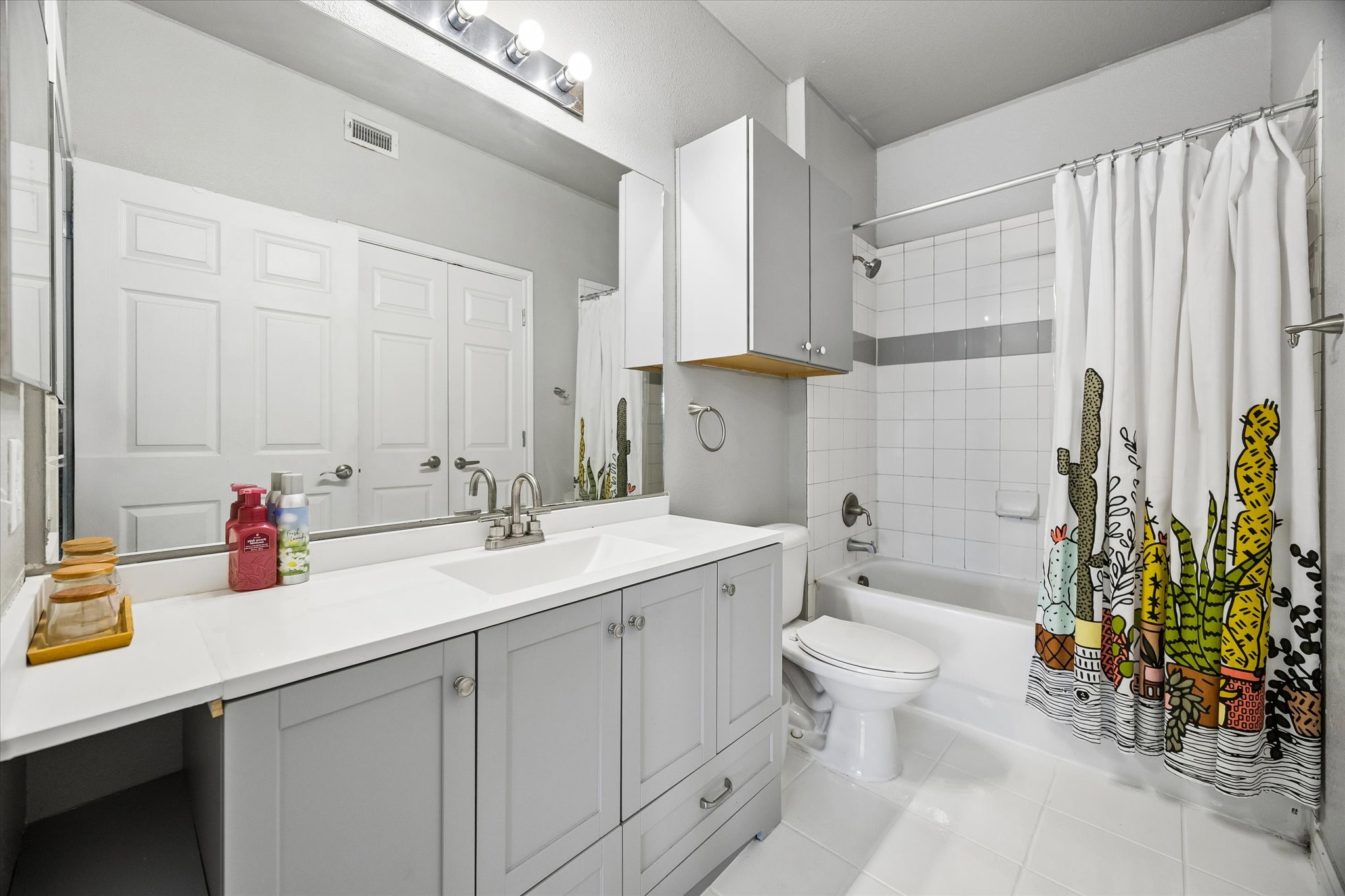 2502 Leon Street, Unit 506 Austin, TX 78705 - Photo 13 of 15 a bathroom with a double vanity sink toilet and shower