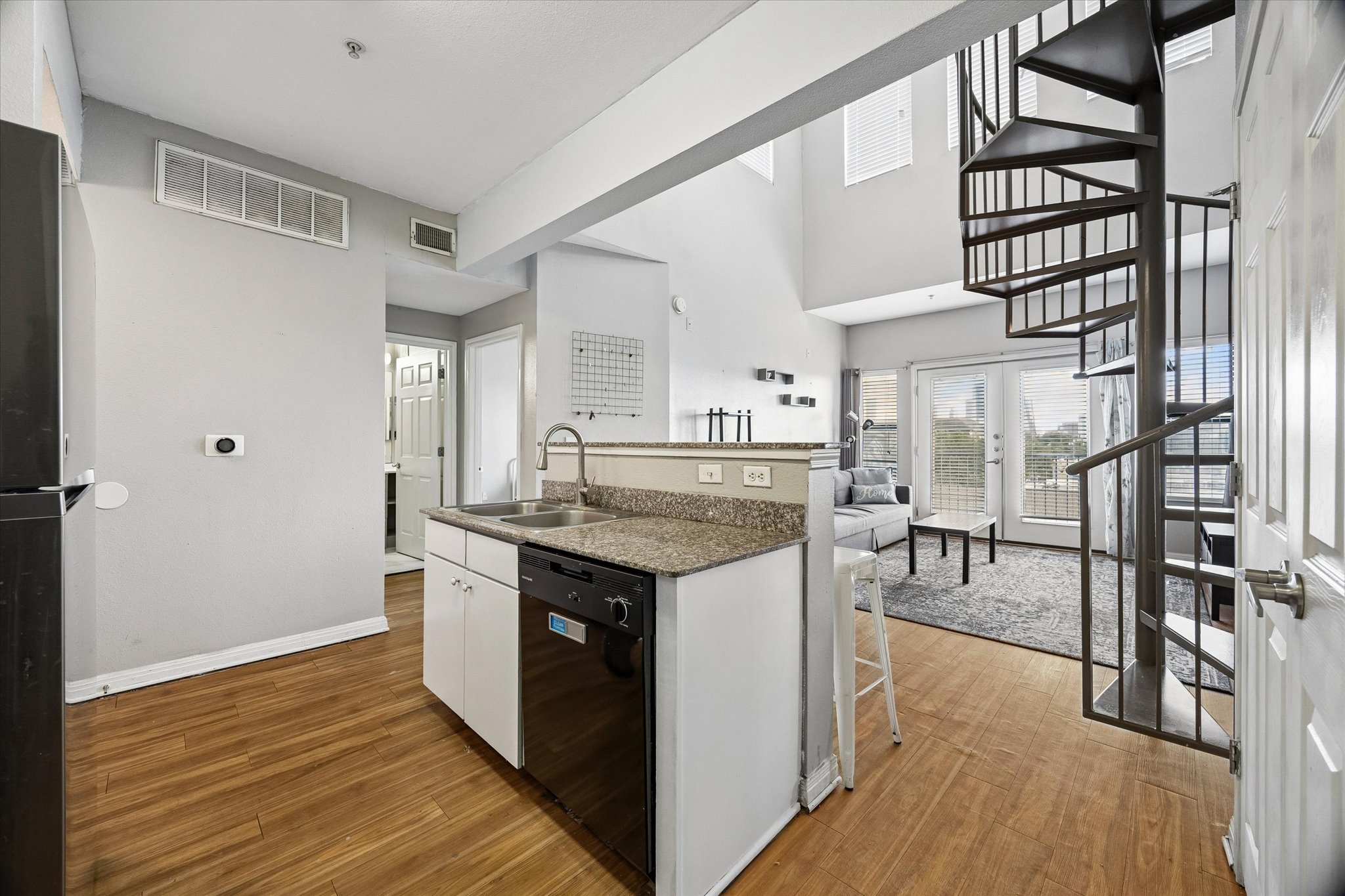 2502 Leon Street, Unit 506 Austin, TX 78705 - Photo 7 of 15 a kitchen with granite countertop a stove and a wooden floors
