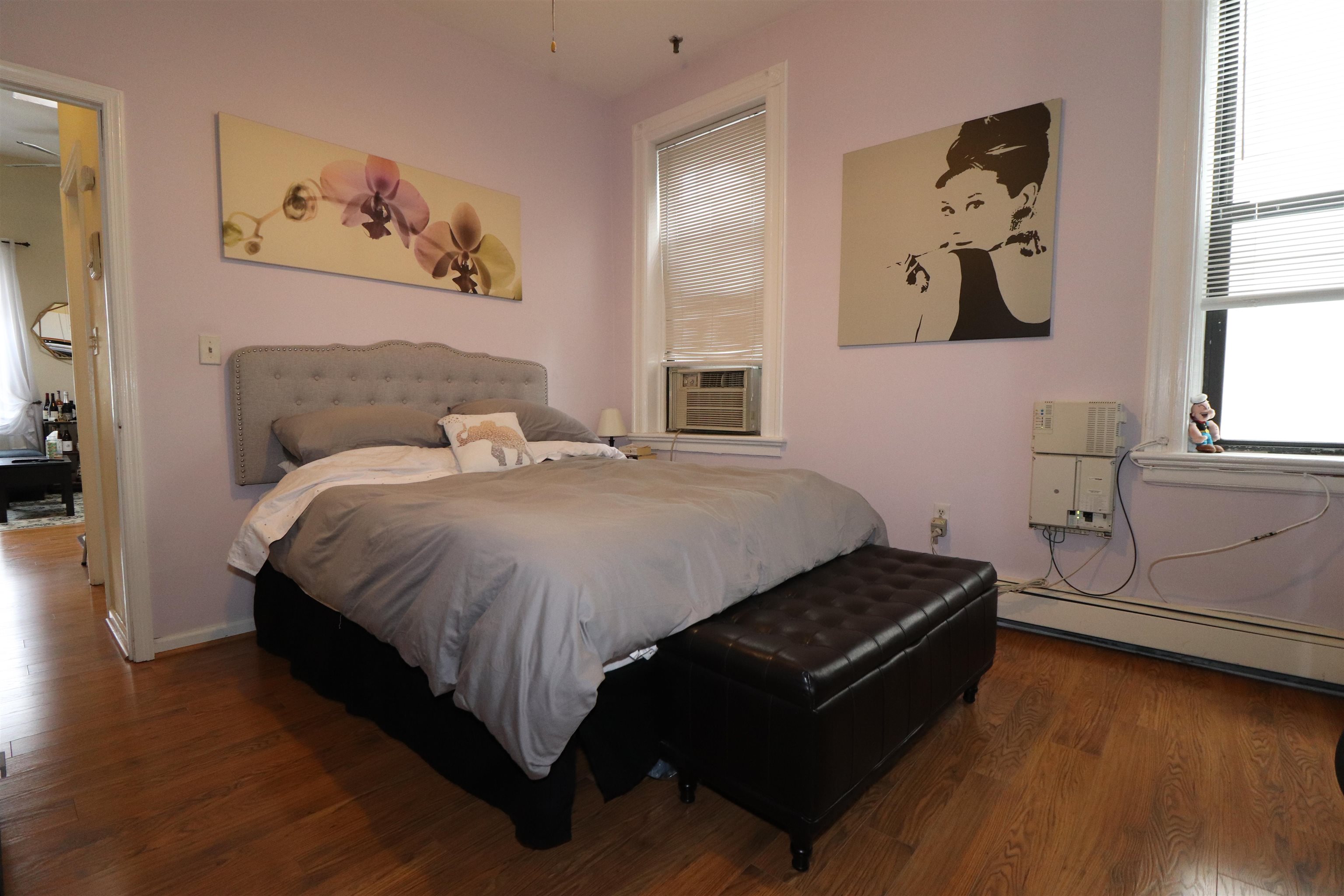 308 8th Street, Unit 2 Hoboken, NJ 07030 - Photo 6 of 8 a bed room with a bed and painting on the wall