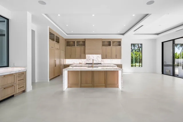 a bathroom with a granite countertop sink and a toilet