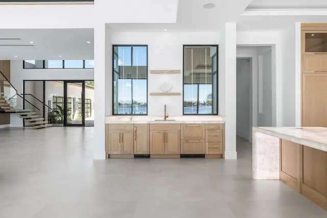a view of an empty room with a large window and a balcony