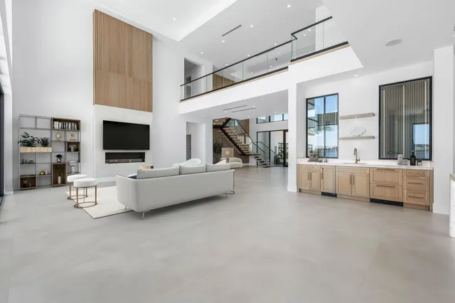 a view of an empty room with a fireplace and a large window