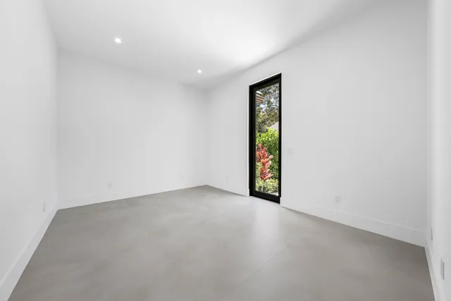 a view of a house with a big yard and potted plants