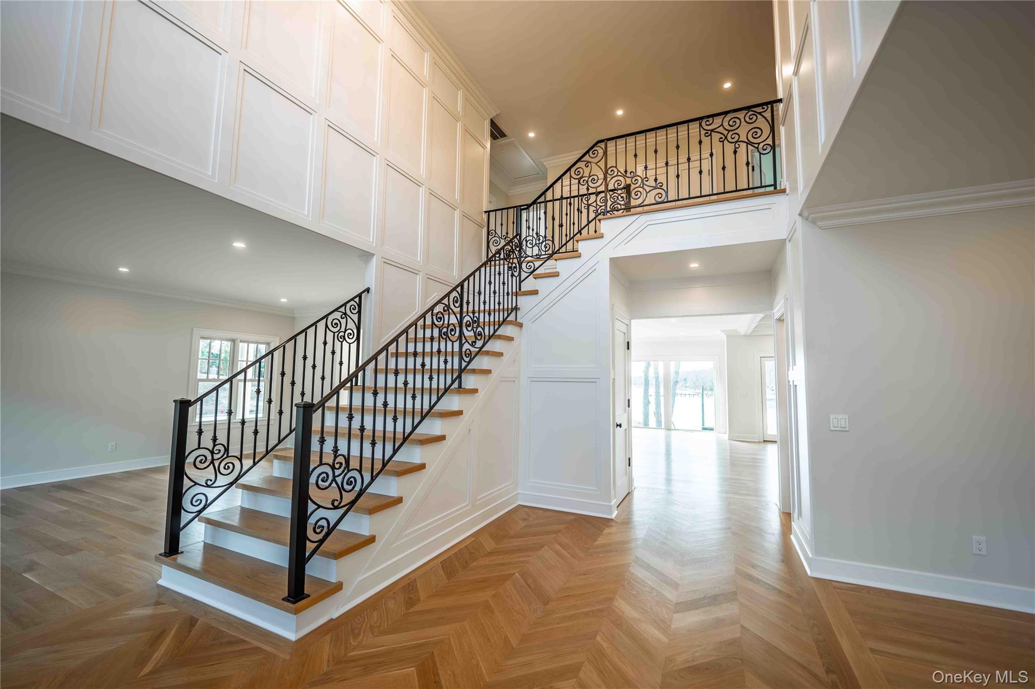 106 Cove Road Asharoken, NY 11768 - Photo 3 of 46 Stairs featuring parquet floors, healthy amount of natural light, recessed lighting, a decorative wall, and crown molding