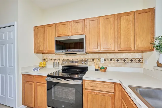 a kitchen with stainless steel appliances a stove a microwave and cabinets