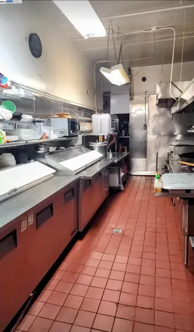 a kitchen with stainless steel appliances a sink stove and cabinets