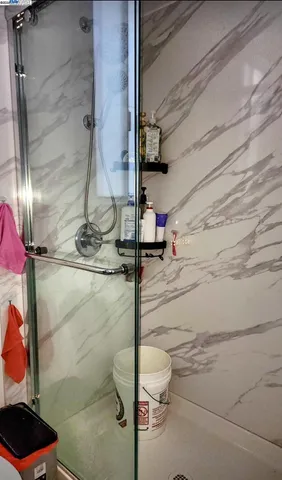 a bathroom with a toilet and a shower