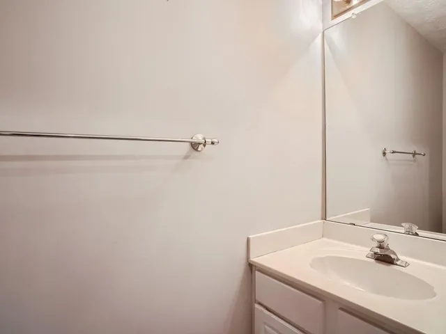 a bathroom with a sink and vanity
