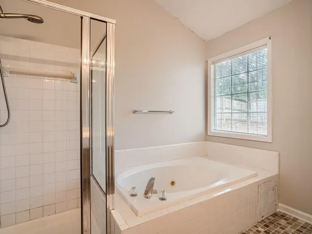 a bathroom with a bathtub and a shower