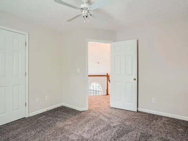 an empty room with closet and mirror