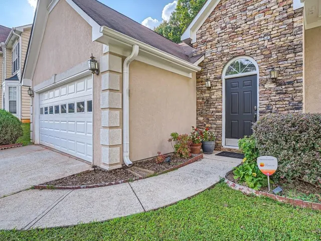 a front view of a house with a garden