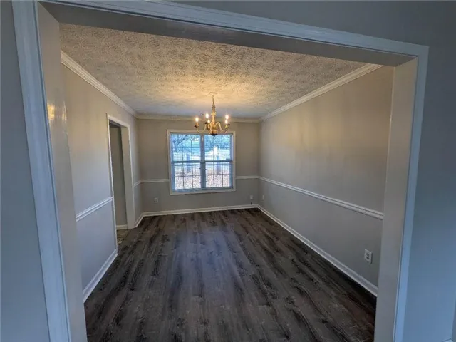 a view of entryway with wooden floor and chandelier