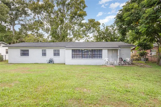 a backyard of a house with barbeque oven
