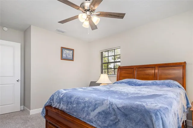 a bedroom with a large bed and a chandelier
