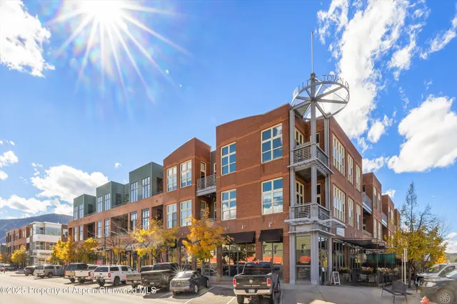 a city street lined with buildings and cars
