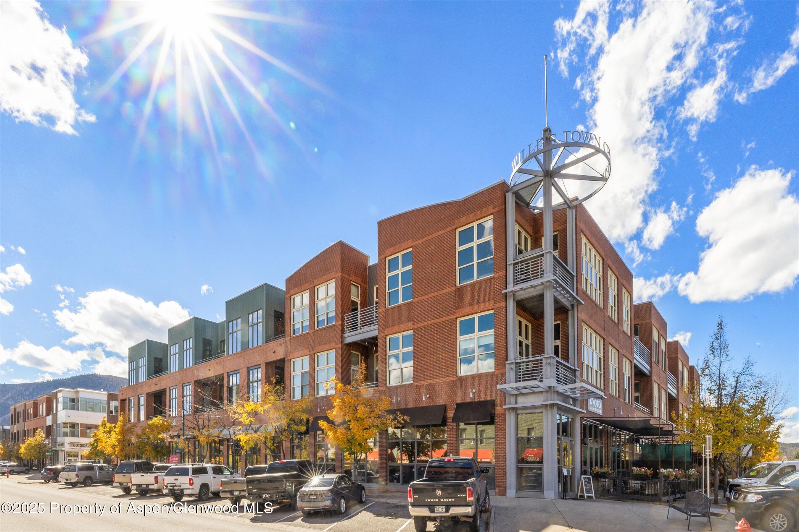 a city street lined with buildings and cars