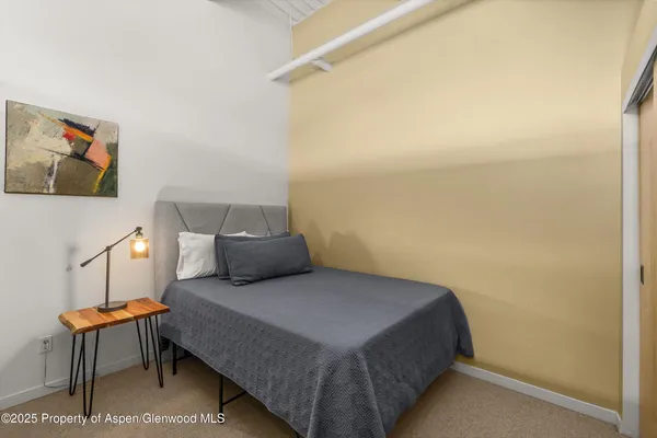 a bedroom with a bed and chair
